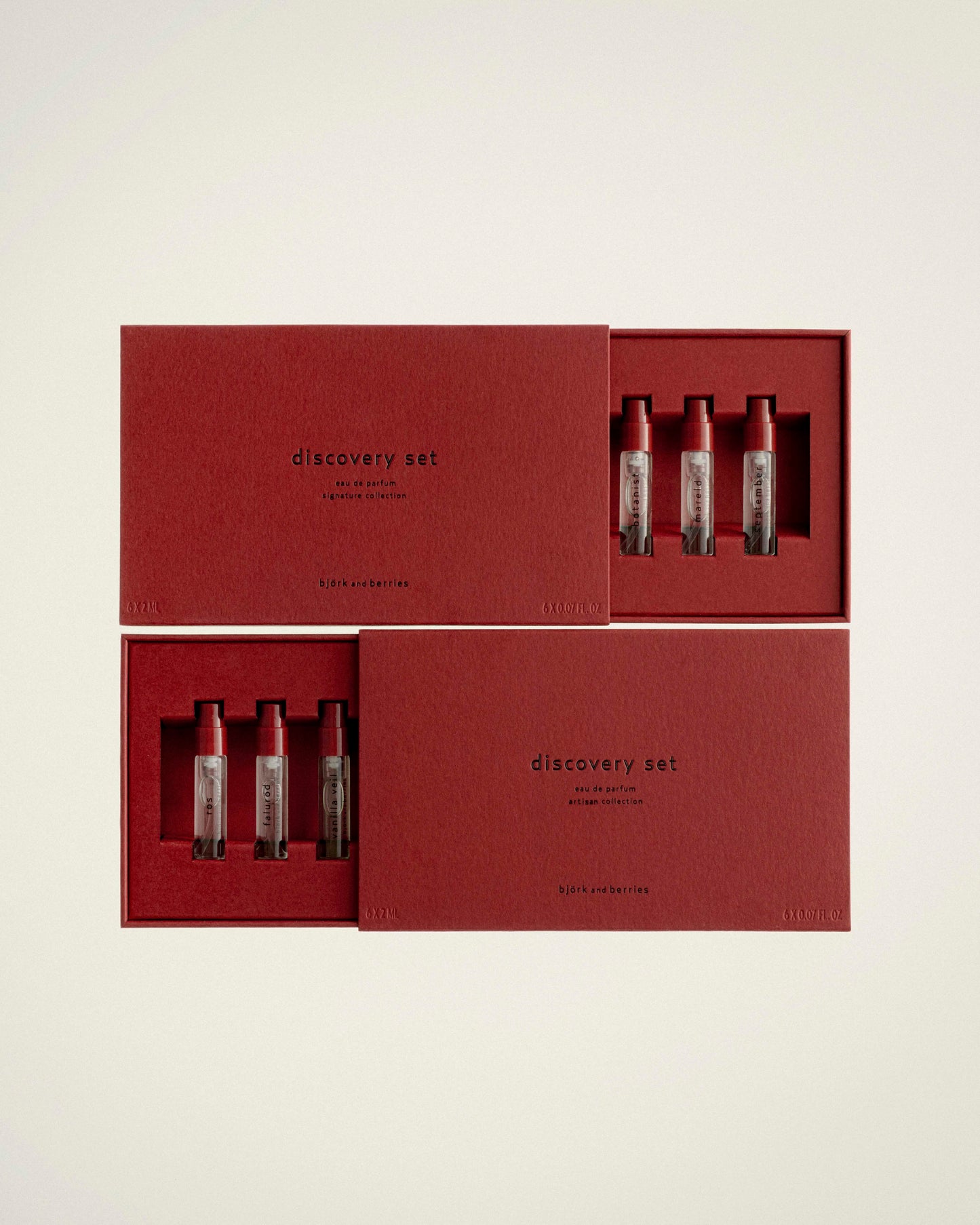 BJORK AND BERRIES Eau de Parfum Discovery Set, Signature Collection gift boxes containing three small cosmetic vials each, arranged on a light warm gray background. The boxes are labeled 'discovery set' and appear to be the product packaging.